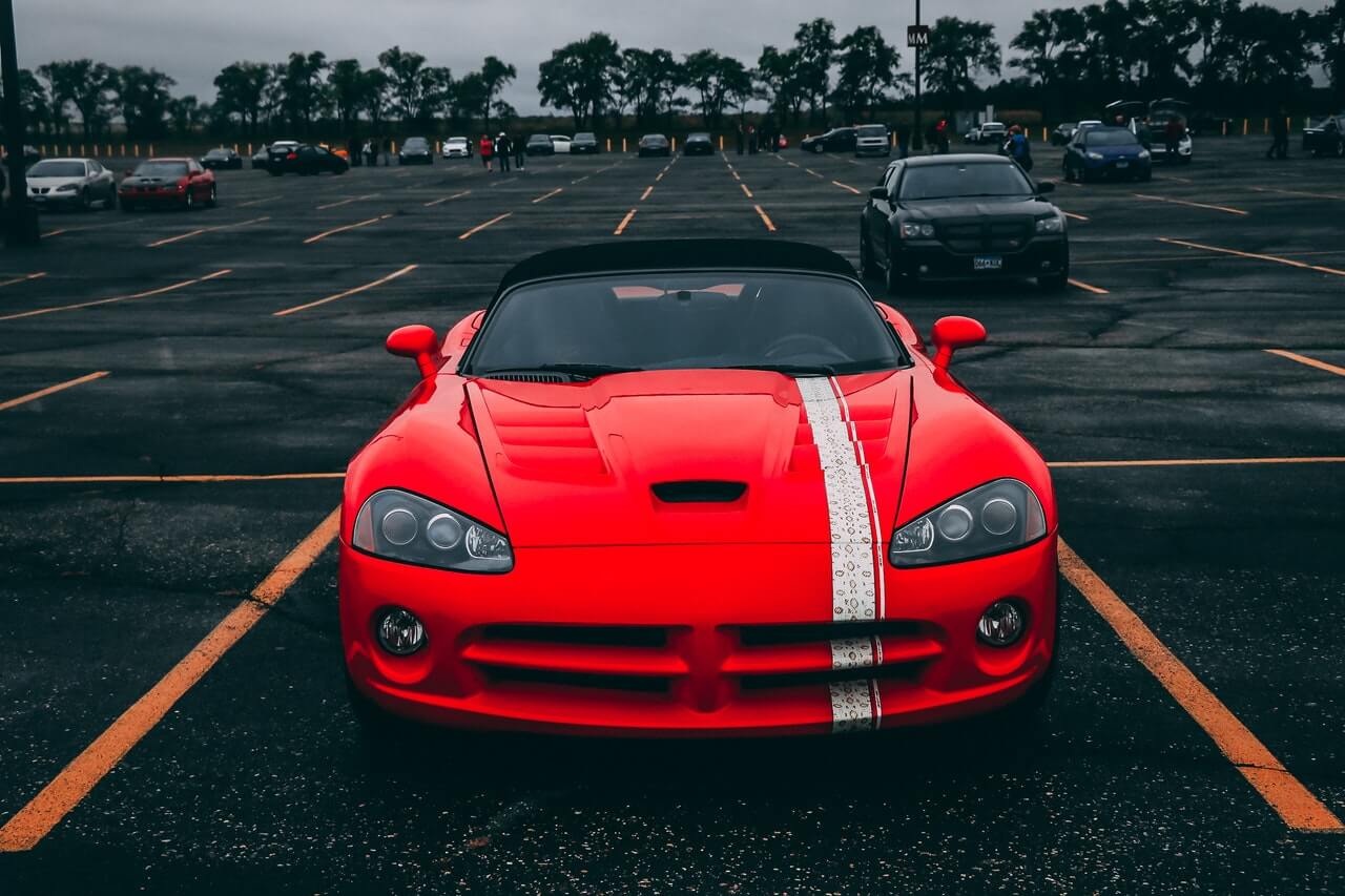 Red sports car parked in a parking lot