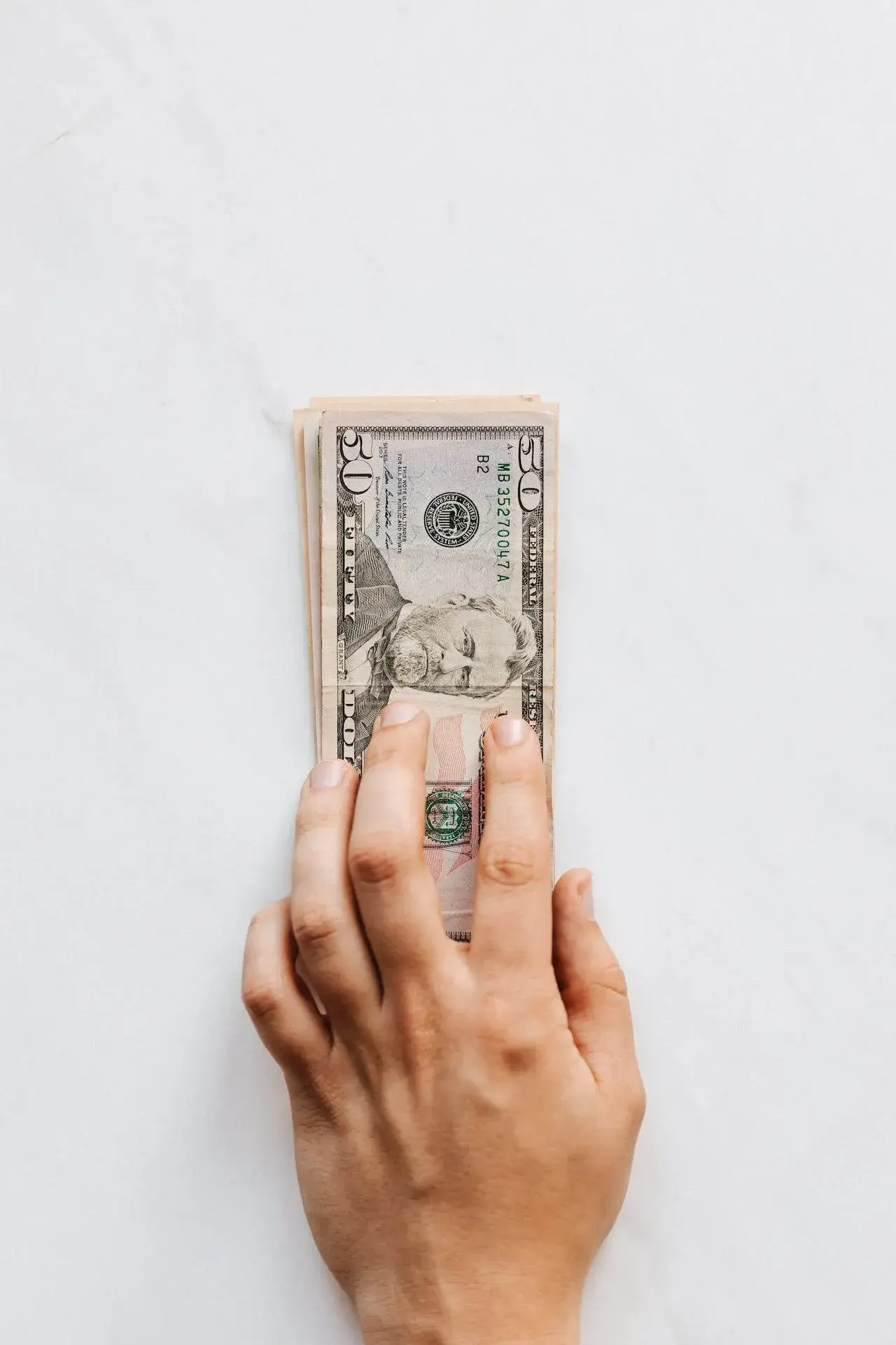 Hand that hands 50 dollars Hand that hands 50 dollars